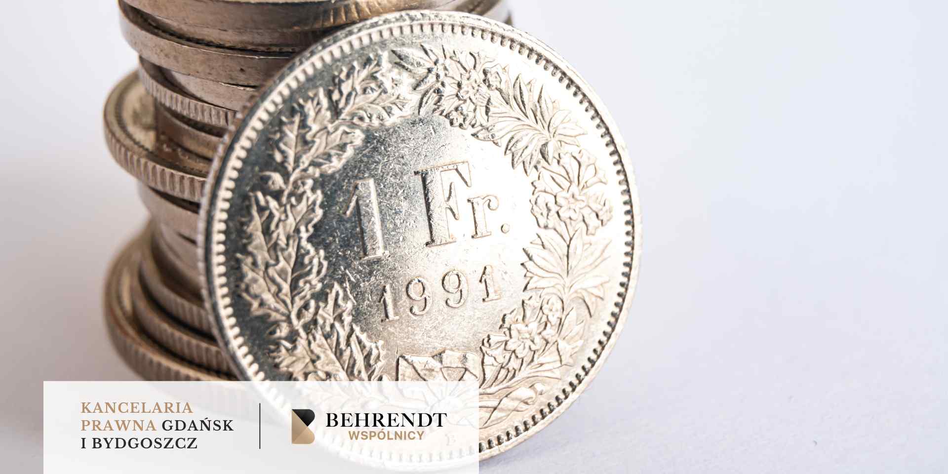 Srebrna moneta o nominale 1 franka szwajcarskiego z 1991 roku oparta o stos innych monet na jasnym tle.