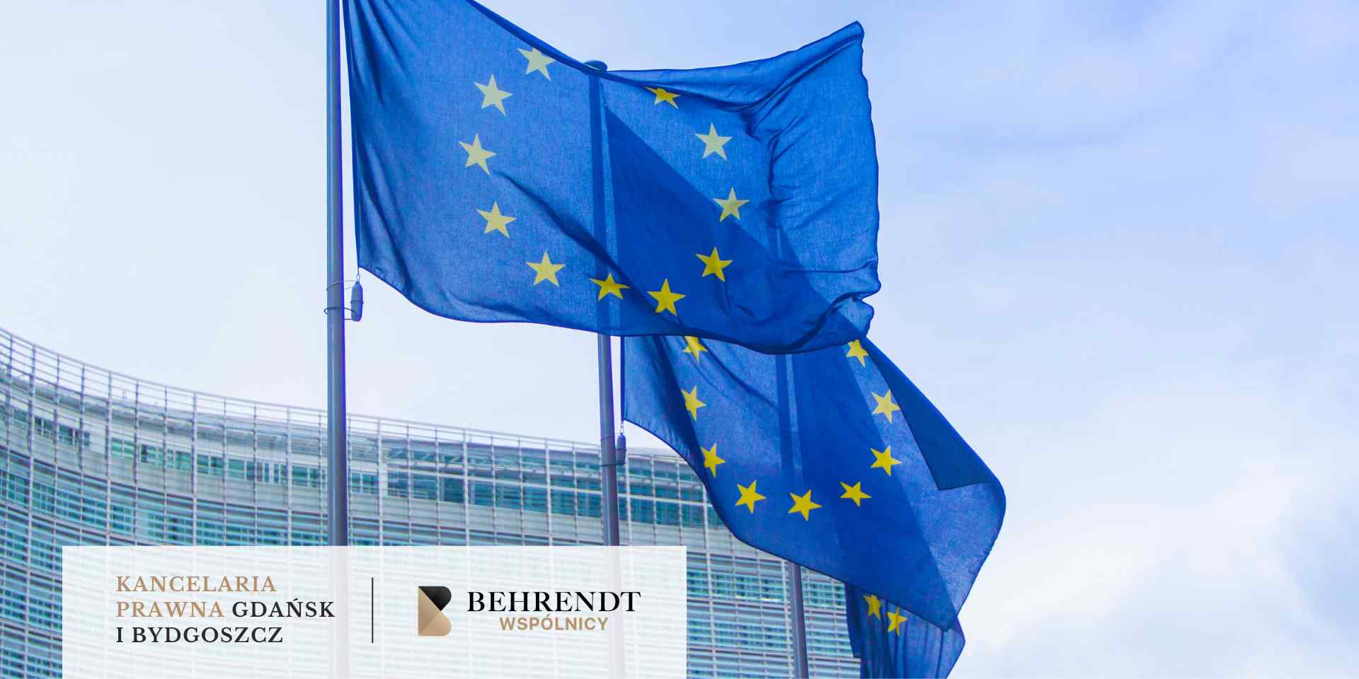 Szerokie ujęcie trzech flag Unii Europejskiej powiewających na wietrze przed nowoczesnym budynkiem o szklanej fasadzie.