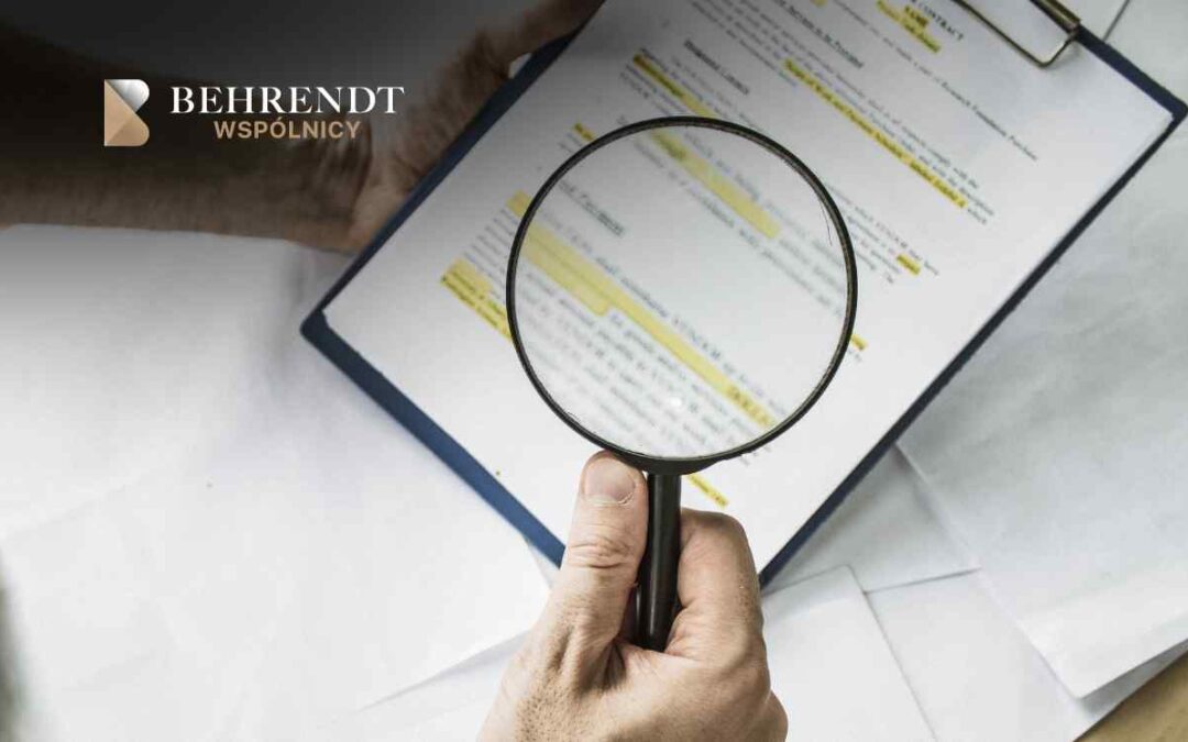 Behrendt Wspólnicy logo in the top-left with a hand holding a magnifying glass over a clipboarded document having highlighted text (close-up).