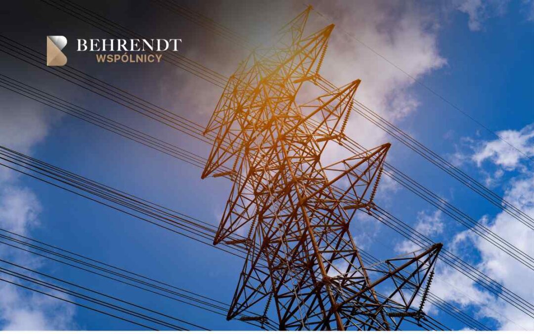 High-voltage transmission tower and cables against a blue sky; Behrendt Wspólnicy logo in the top-left corner.